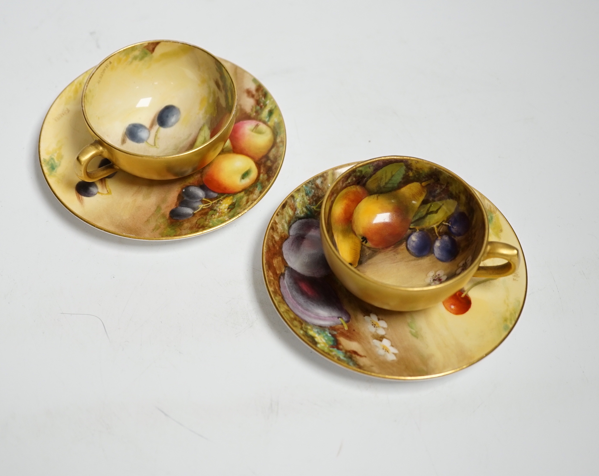 A pair of Royal Worcester fruit painted miniature cabinet cups and saucers, signed F. Harper and W.H. Austin